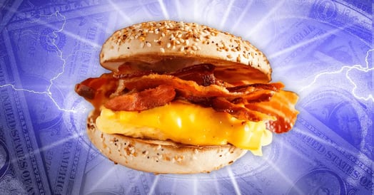 A bacon, egg, and cheese sandwich on an everything bagel against a purple backdrop with lightning and dollar bills.